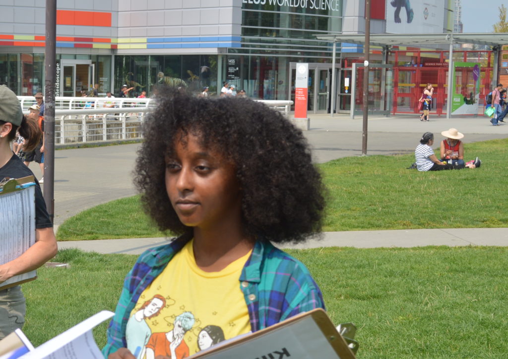 Haleluya Hailu cavasses in front of Science World